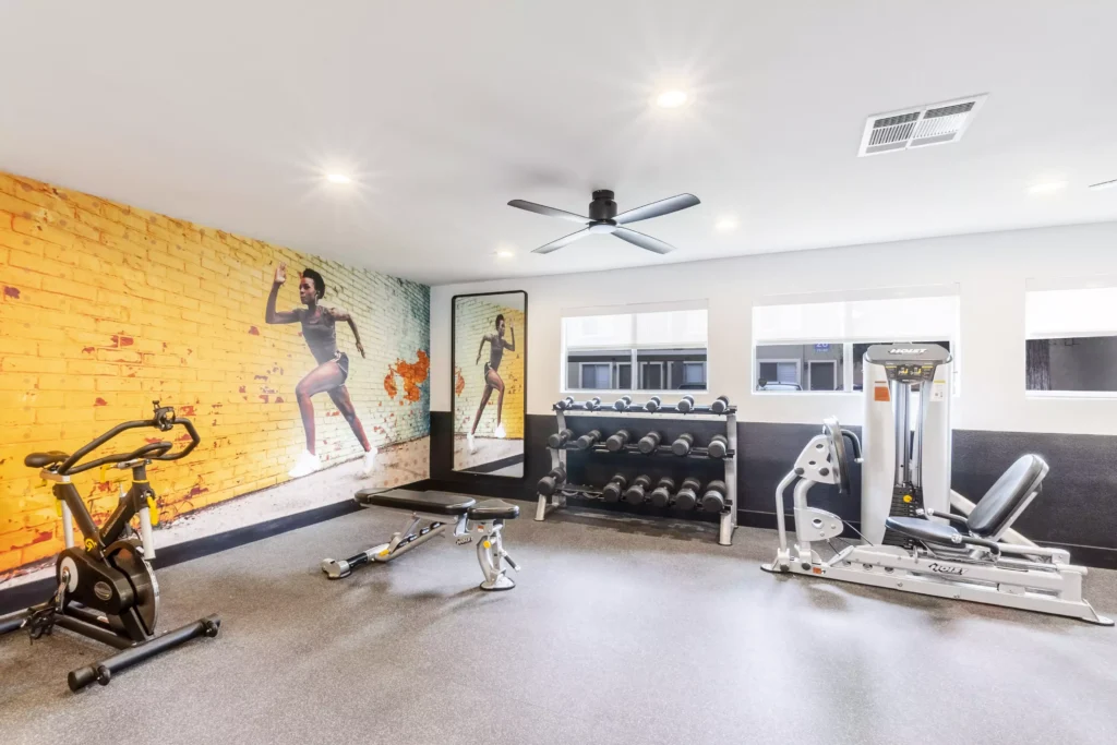 Fitness center with strength training machines and dumbbells