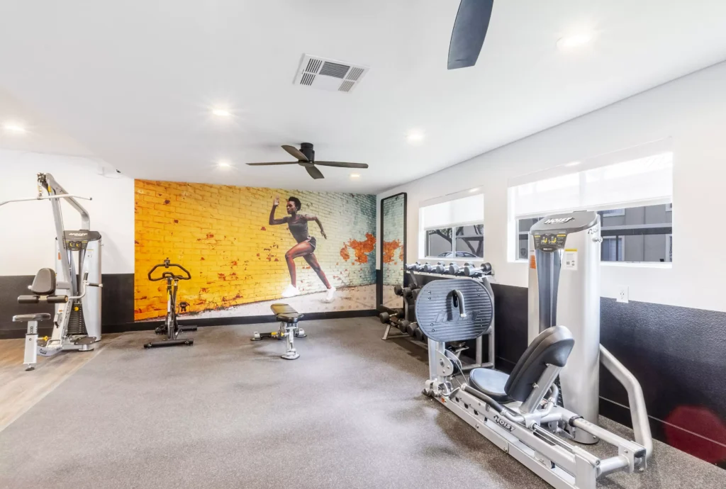 Fitness center with strength training machines and dumbbells
