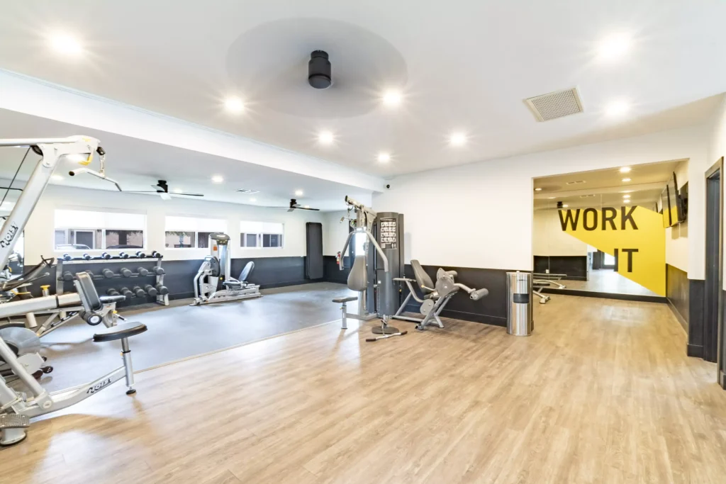 Fitness center with strength training machines and dumbbells
