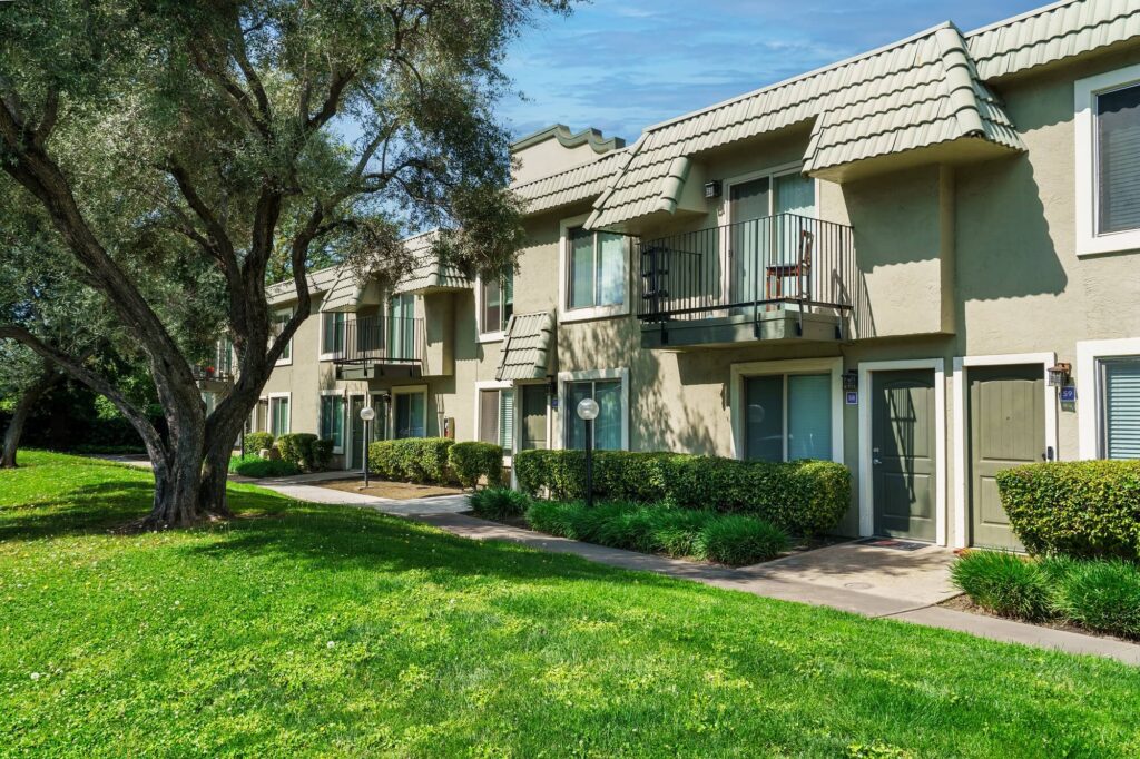 Exterior view of apartment complex with green landscaping